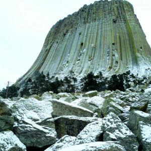 A towering volcanic cone of grey green rock in winter.