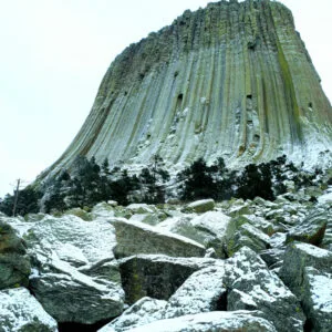 A towering volcanic cone of grey green rock in winter.